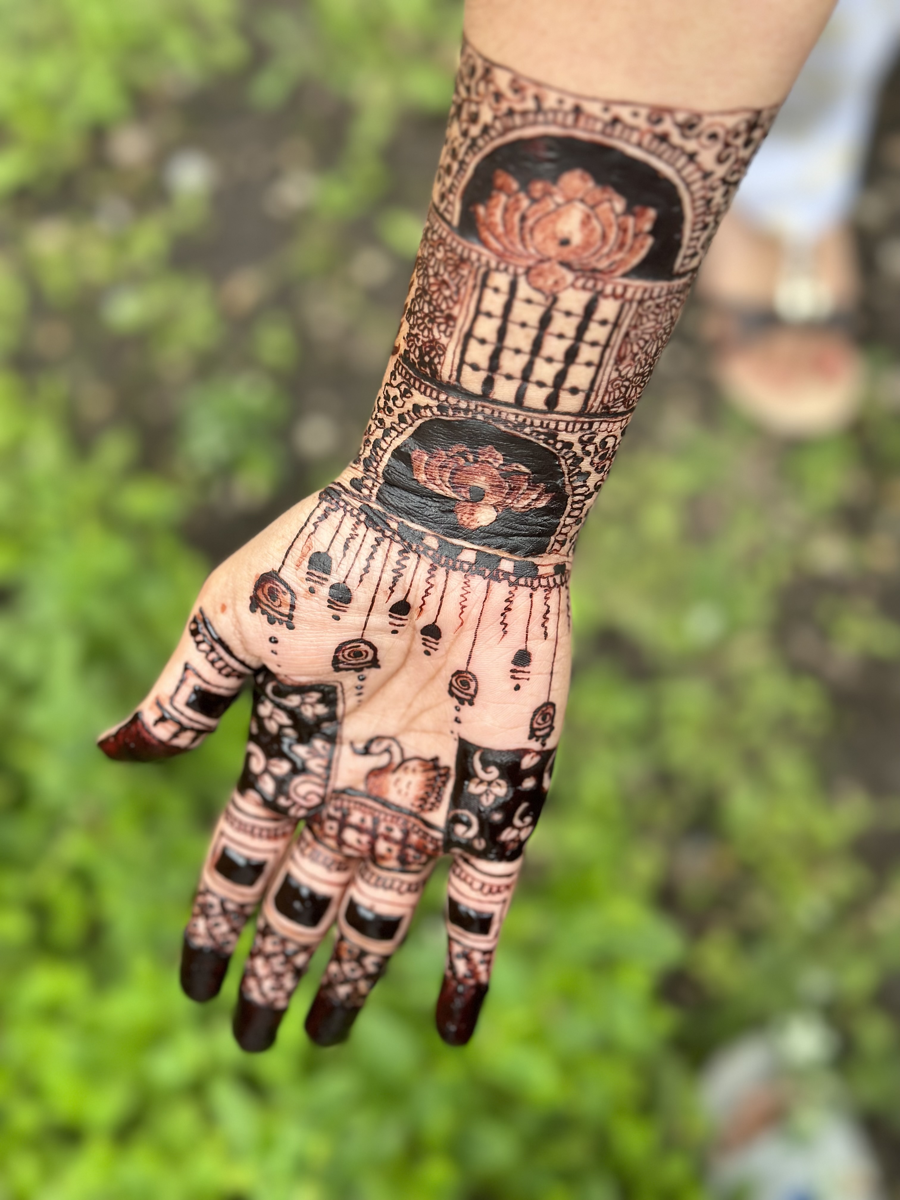 Intricate full hand mehndi with lotus motifs